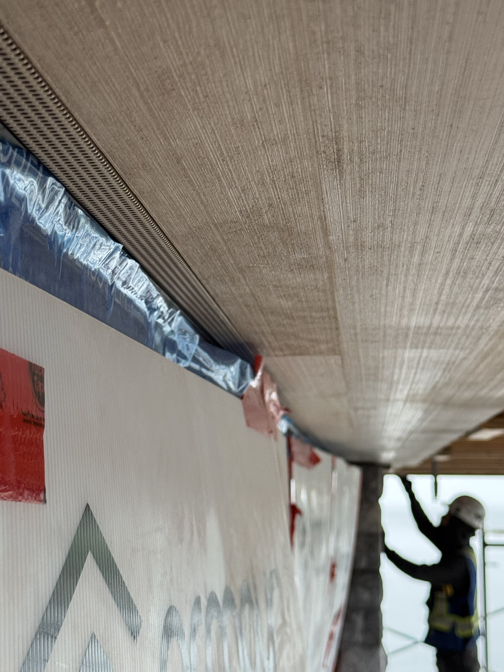 Hemlock soffit meeting a stone feature wall at the Cove Beach custom home, Sechelt