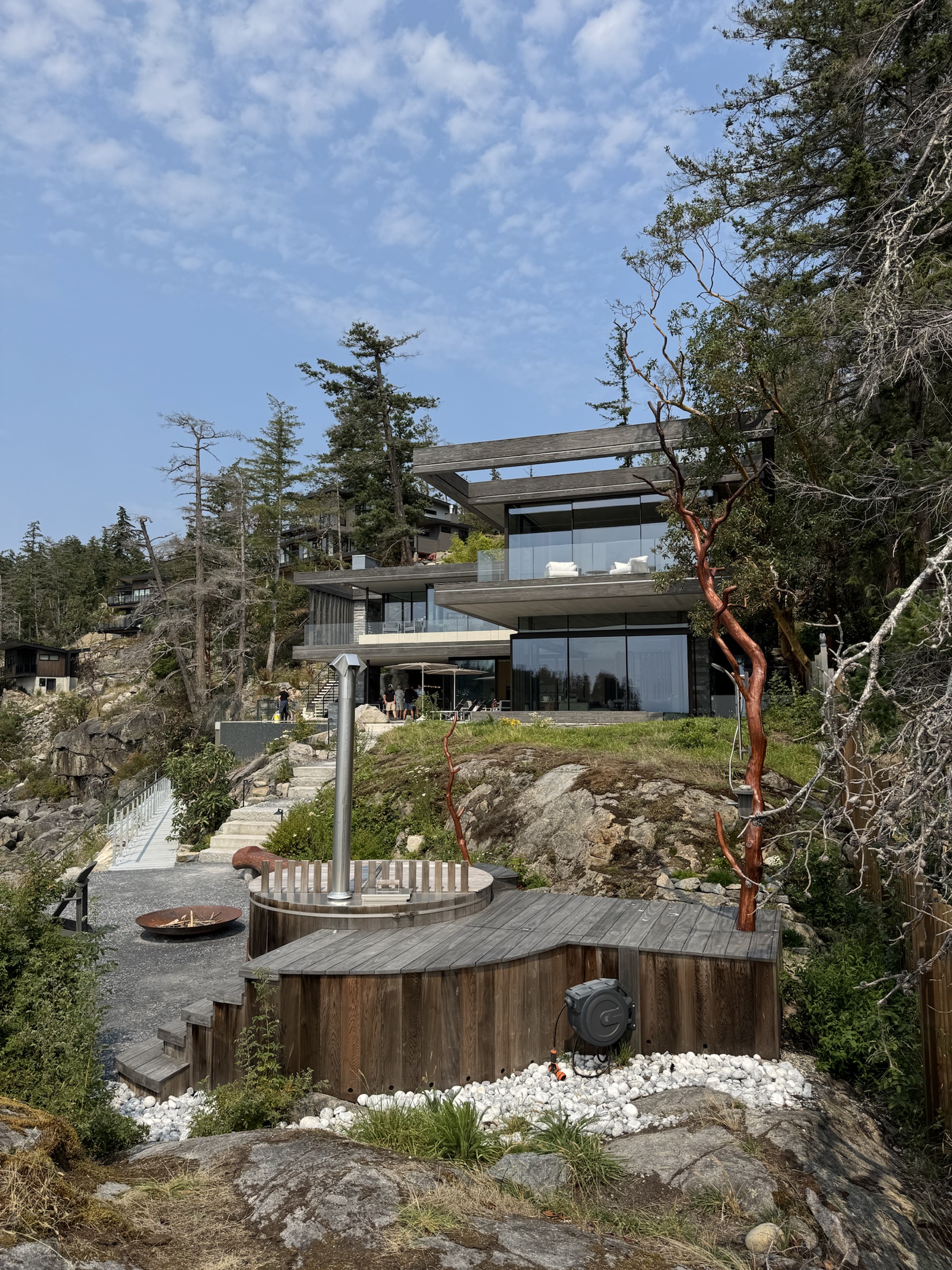 Cove Beach custom home, Sechelt — modern glass waterfront house on a rock bluff, ocean beyond