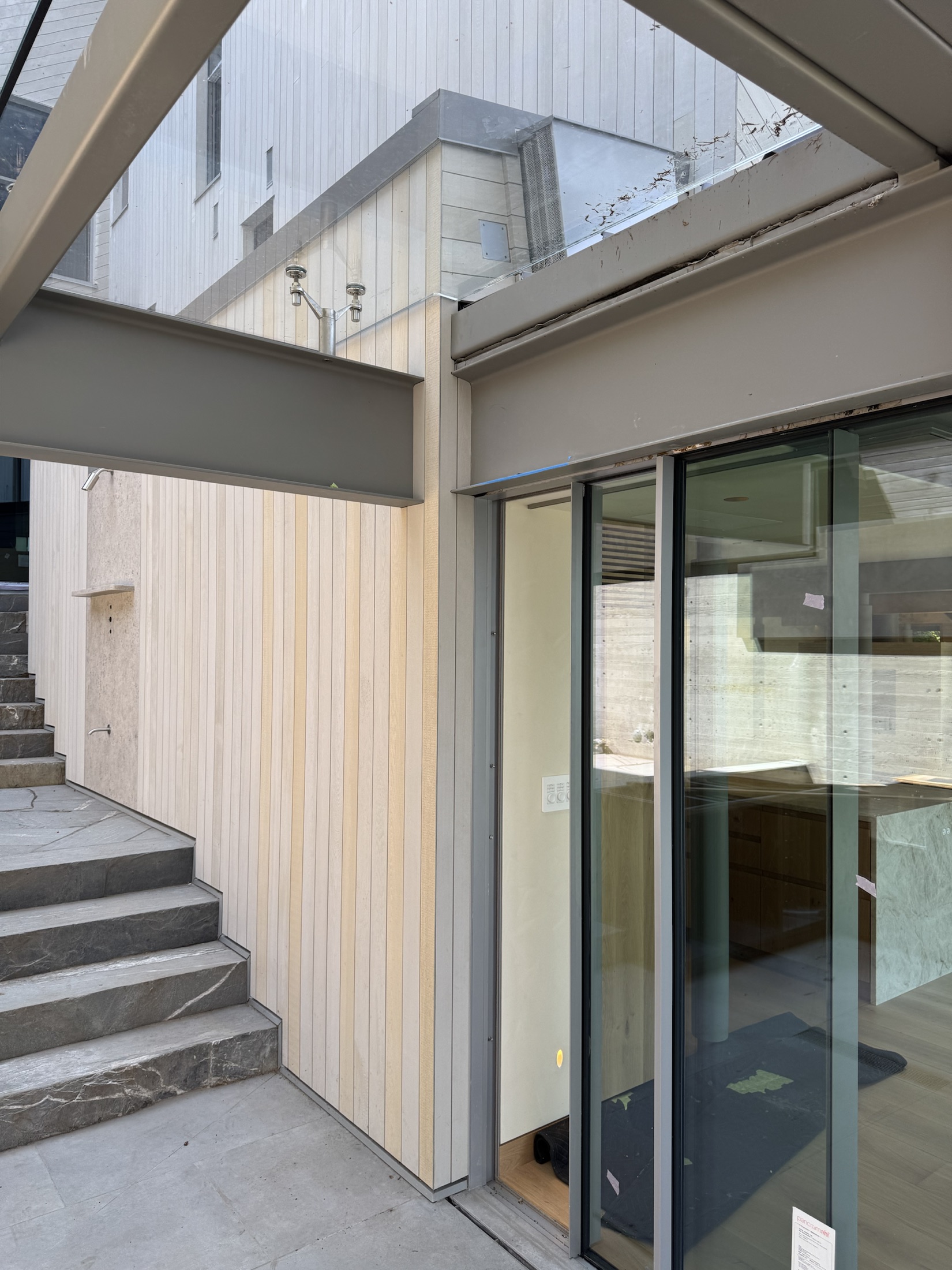 Cedar siding and window integration at the Lawrence Way custom home, West Vancouver