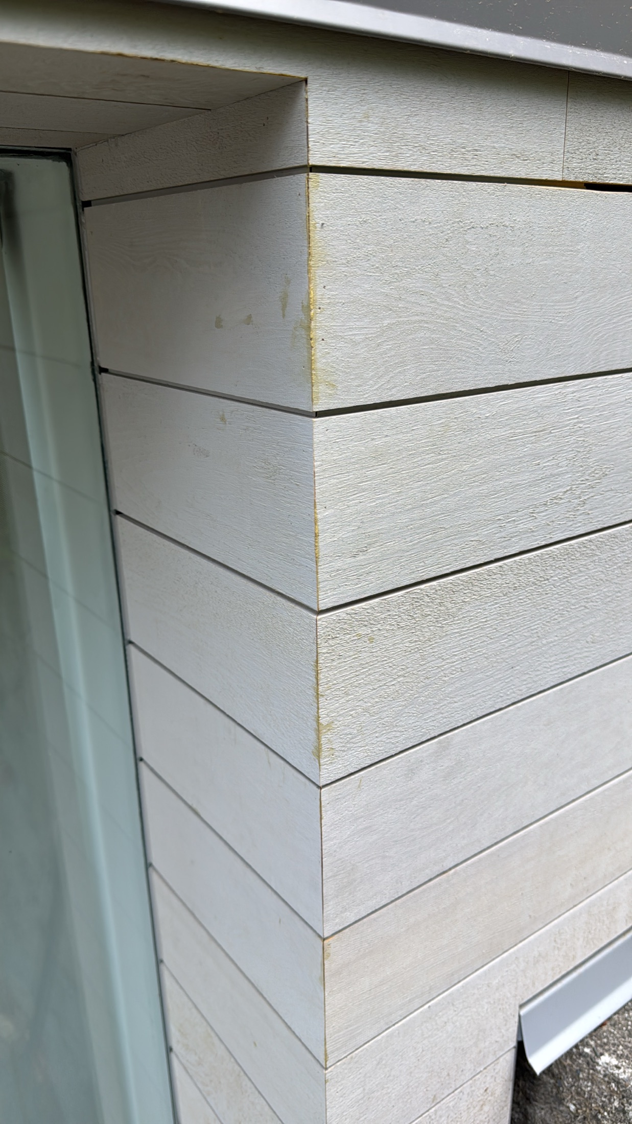 Mitered corner detail on cedar rainscreen siding at the Lawrence Way custom home, West Vancouver — boards wrapping the corner with no trim