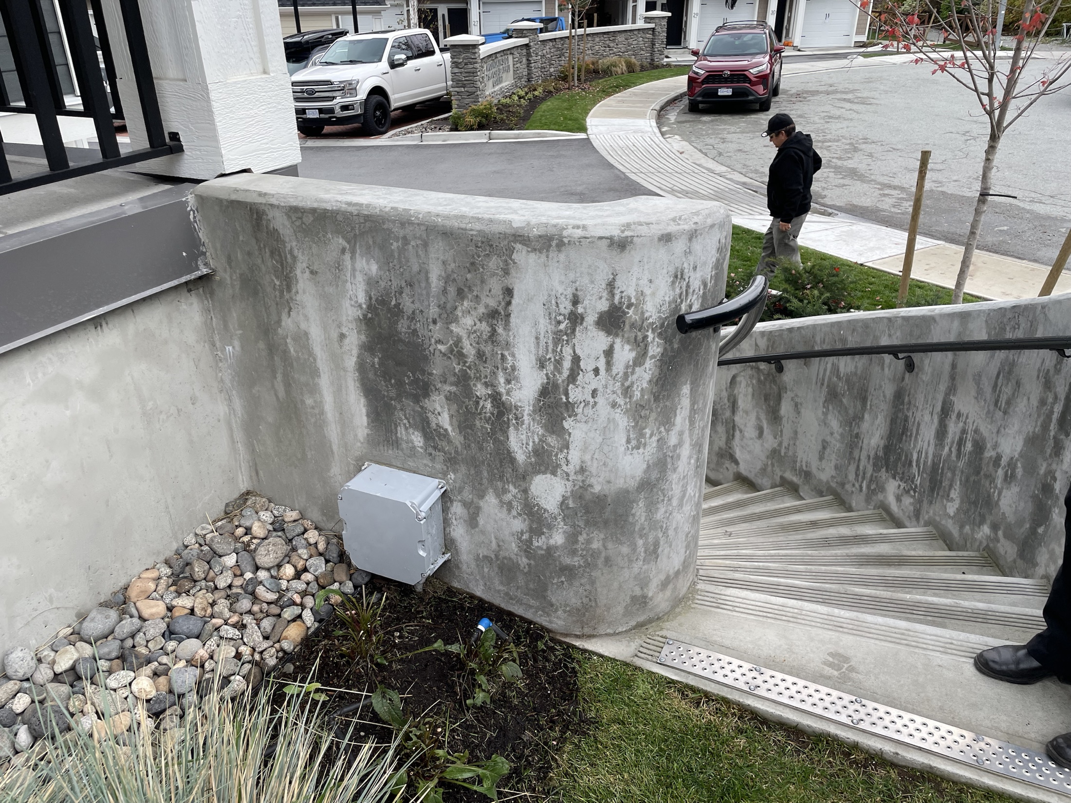 Finished curved cast-in-place concrete stairwell wall on a residential site