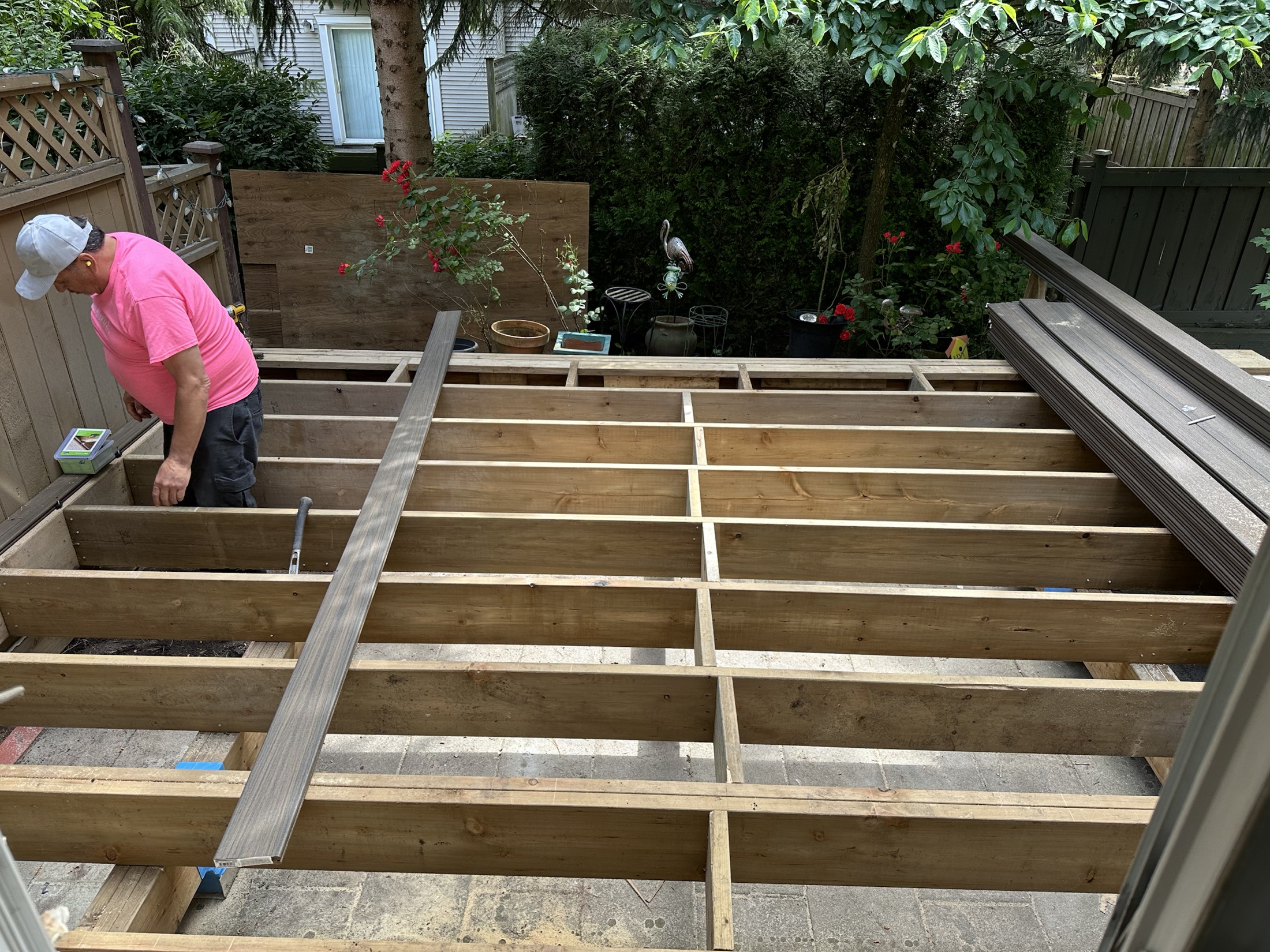 New joist framing for the Paula Dhillon composite deck built over the old paver patio, Surrey