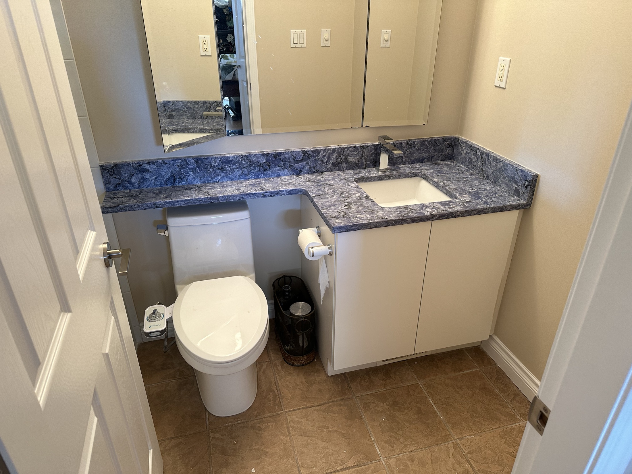 New powder room with a blue quartz counter at the Paula Dhillon renovation, Surrey