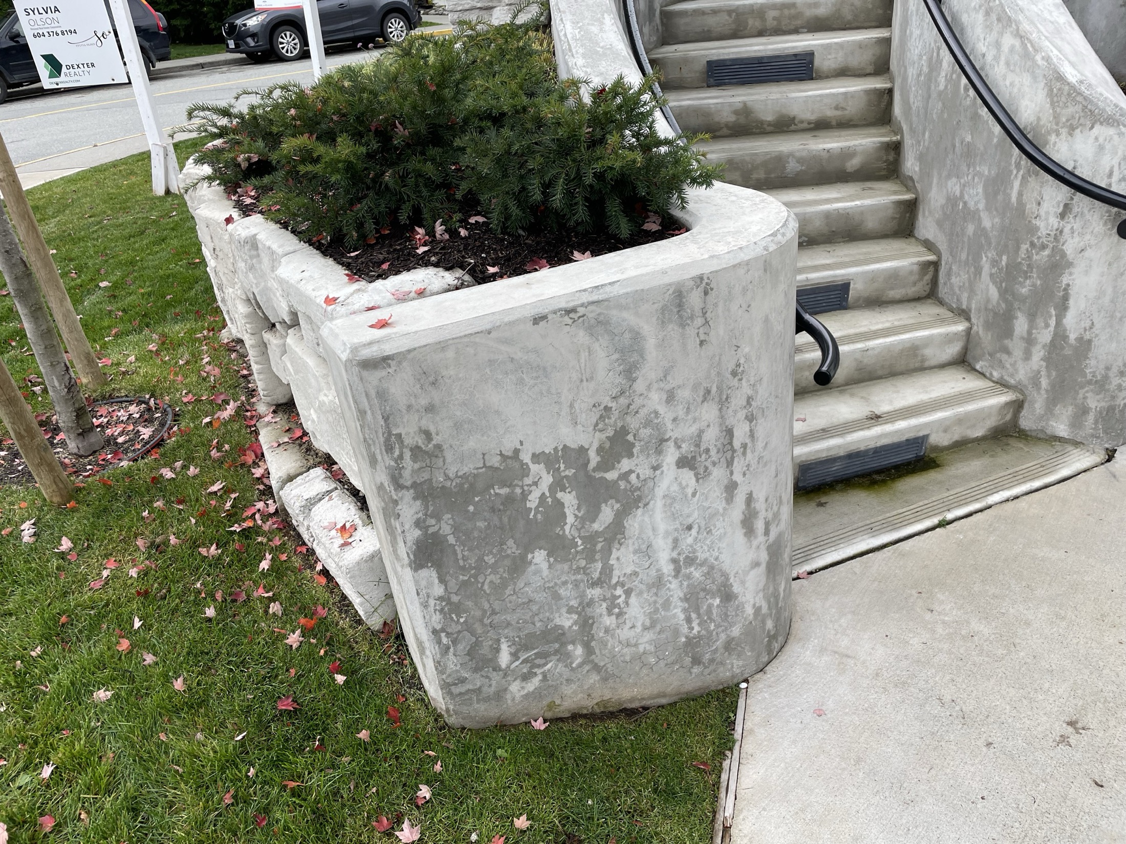 Finished curved concrete stairwell and planter wall on a Pemberton townhouse development