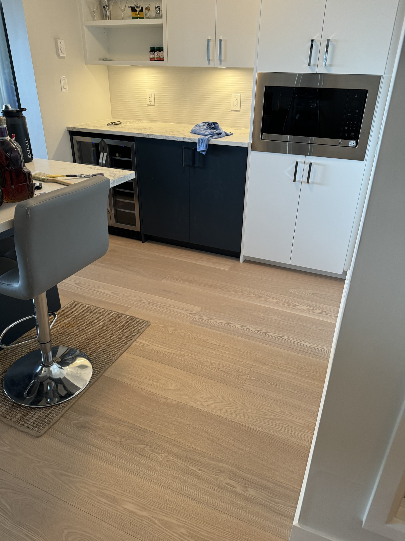 Wende's Remodel kitchen, New Westminster — navy cabinets, marble waterfall island and built-in microwave
